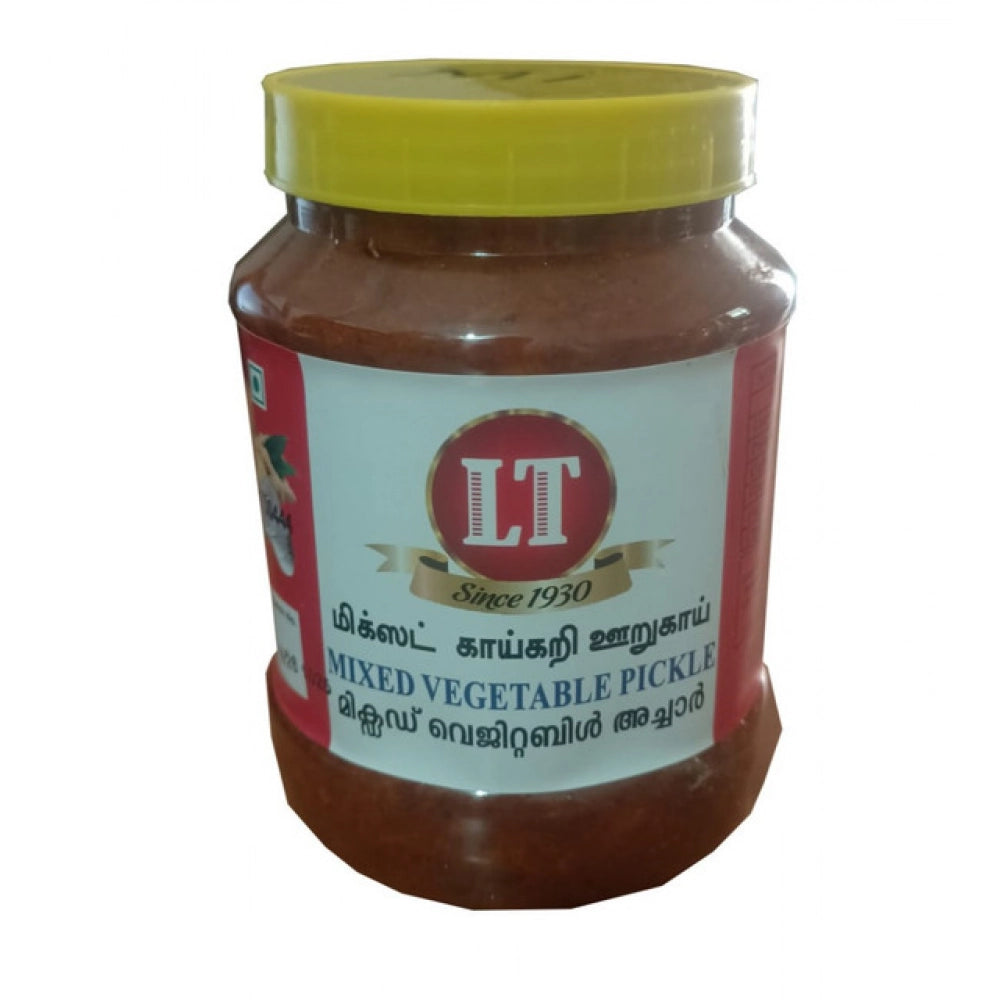 Mixed vegetable pickle in glass jar with green lid and brown contents