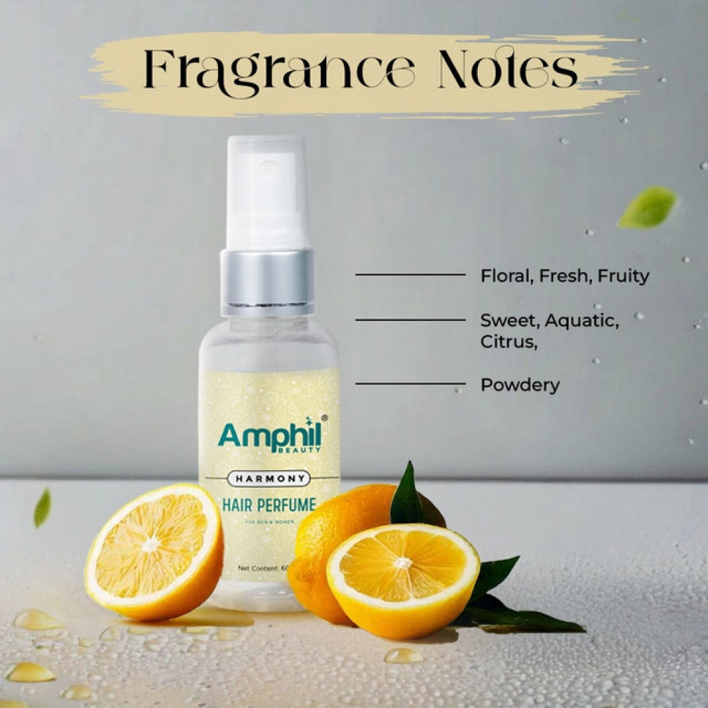 Hair perfume mist spray bottle with golden liquid beside citrus fruit slices