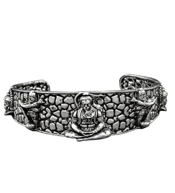 Silver-tone wide cuff bangle with pebble texture and raised Hanumanji medallion