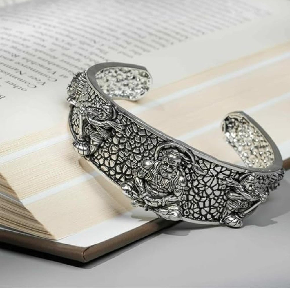 Silver-tone textured bangle cuff with raised Hanumanji figure and inner curved bands