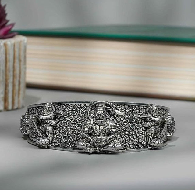 Silver-tone wide cuff bangle, embossed pebble pattern with center Hanumanji medallion