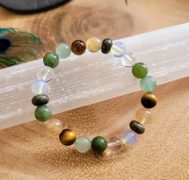 Multicolor crystal bead bracelet with mixed green, black, gold, and opal-clear beads